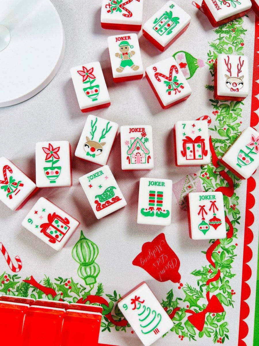 Scarlet Stocking acrylic American mahjong tiles scattered on holiday tablecloth — gift-ready lifestyle layout, Mahjong Loft