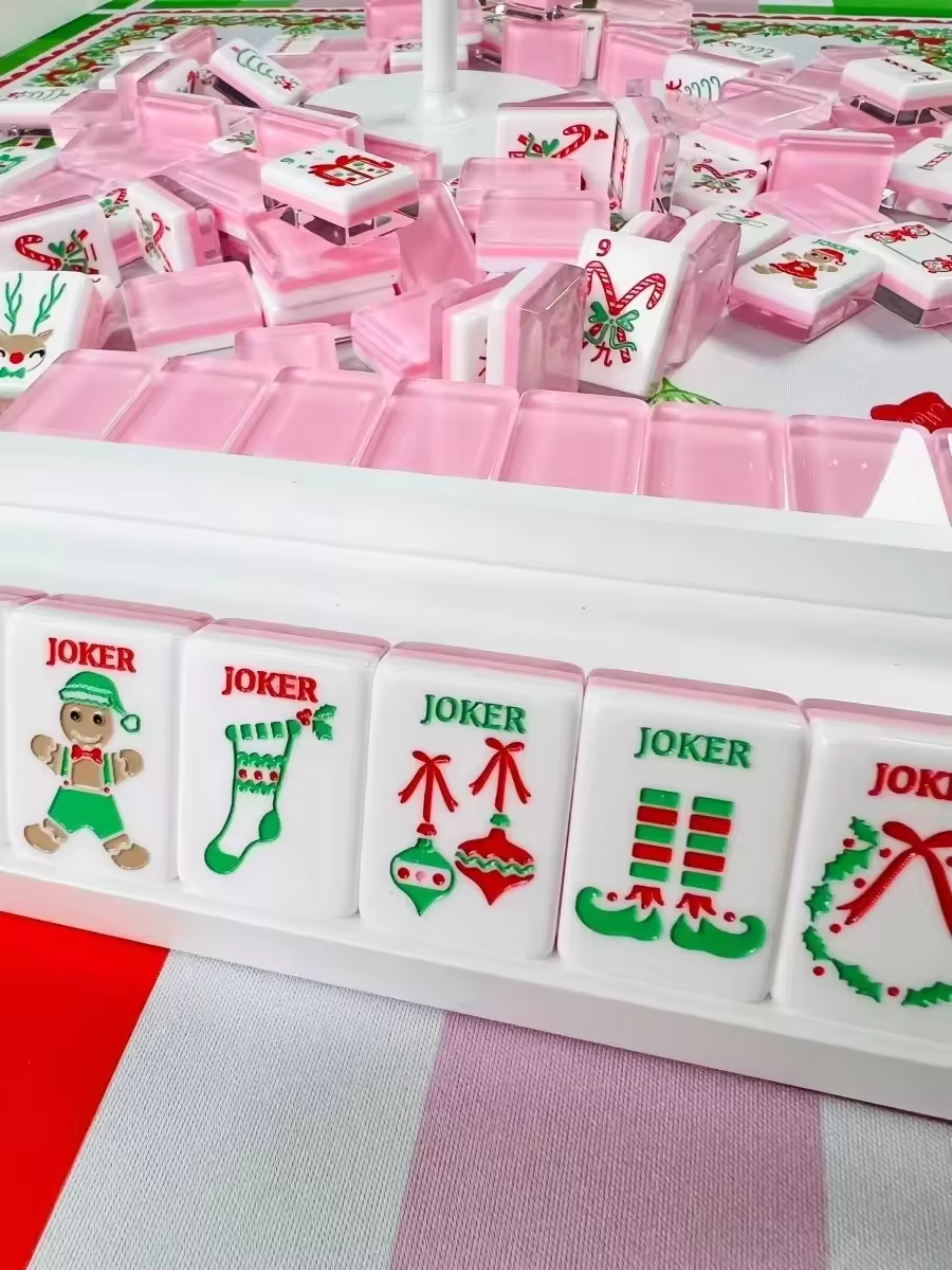 Pink Reindeer acrylic American mahjong tiles arranged for game night — candy cane and tree motifs, Mahjong Loft