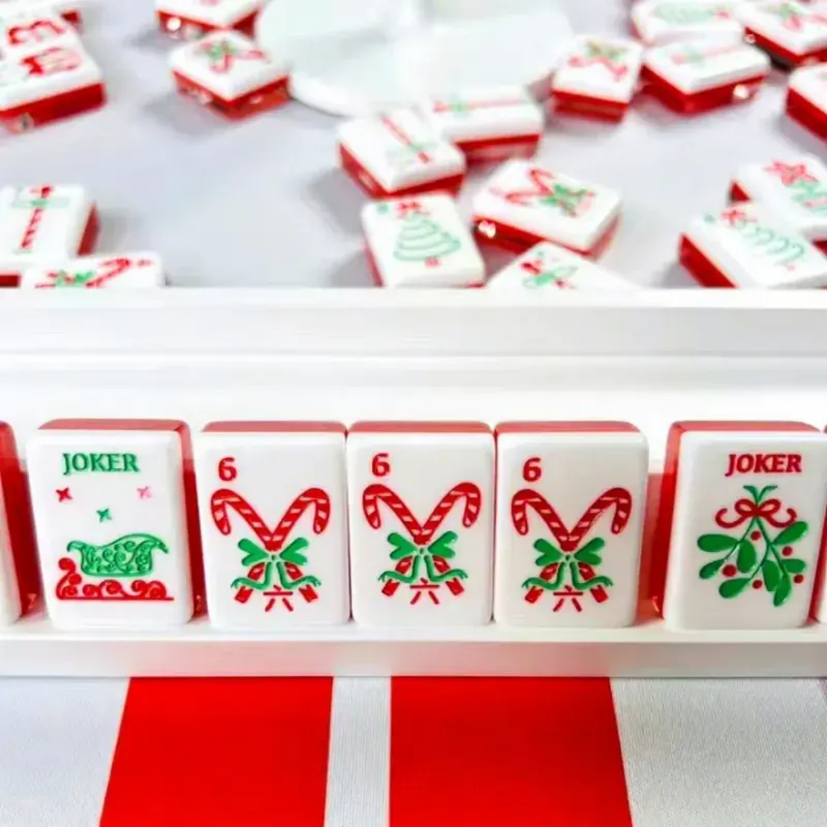 Scarlet Stocking acrylic American mahjong rack close-up with candy cane tiles — red acrylic edge stripe, Mahjong Loft