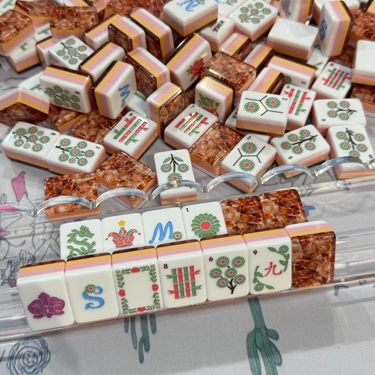 Amber Vine acrylic American mahjong lifestyle rack with faces and copper backs — blue winds jokers and floral vine engravings, Mahjong Loft