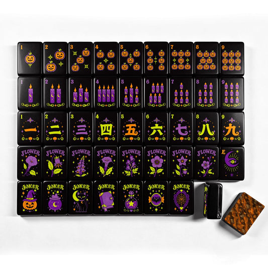 Pumpkin Hex Halloween mahjong tile suit chart with jack-o'-lantern dots, purple candle bams, Chinese numeral cracks, witchy flower tiles, and pumpkin/cat/moon joker tiles