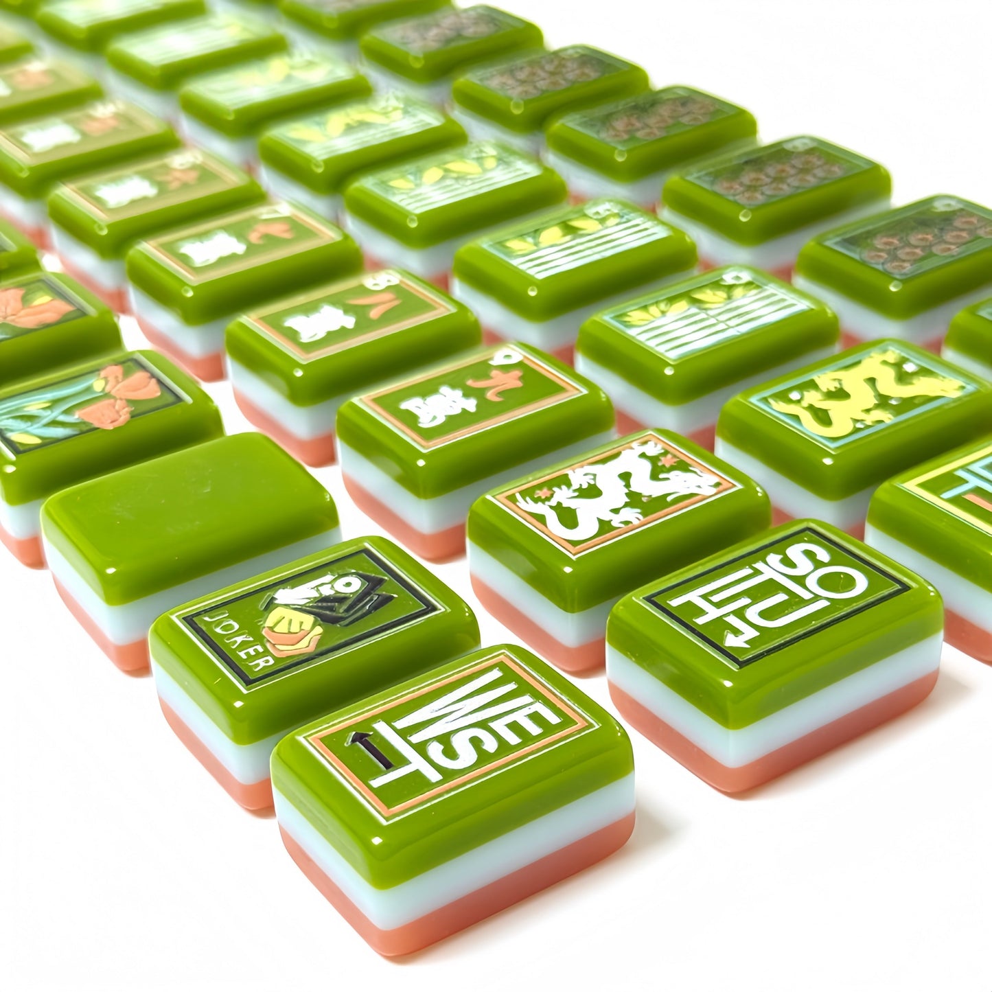 Artisan Grove artistic green and coral acrylic American mahjong tile set tiles arranged on a clear pusher