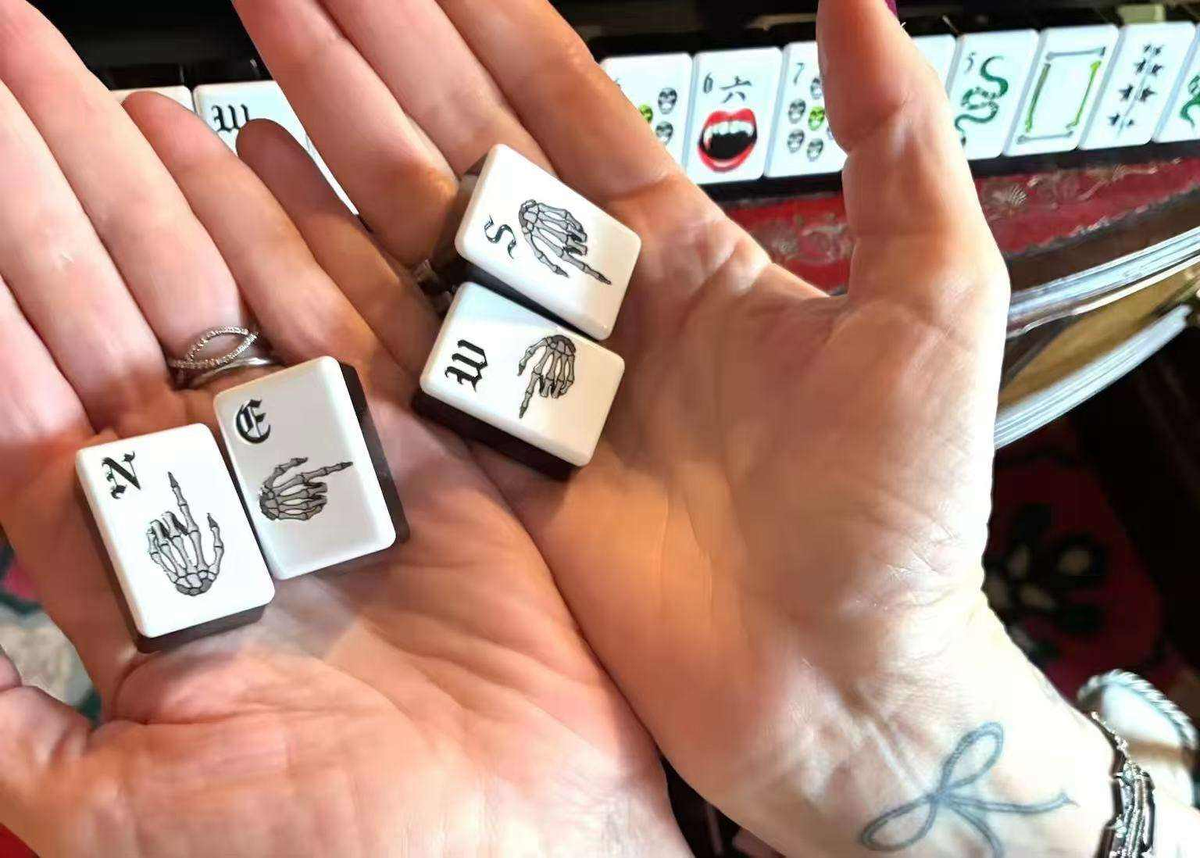 Midnight Fang Halloween acrylic American mahjong skeleton-hand wind tiles held in hands — N E S W detail, Mahjong Loft