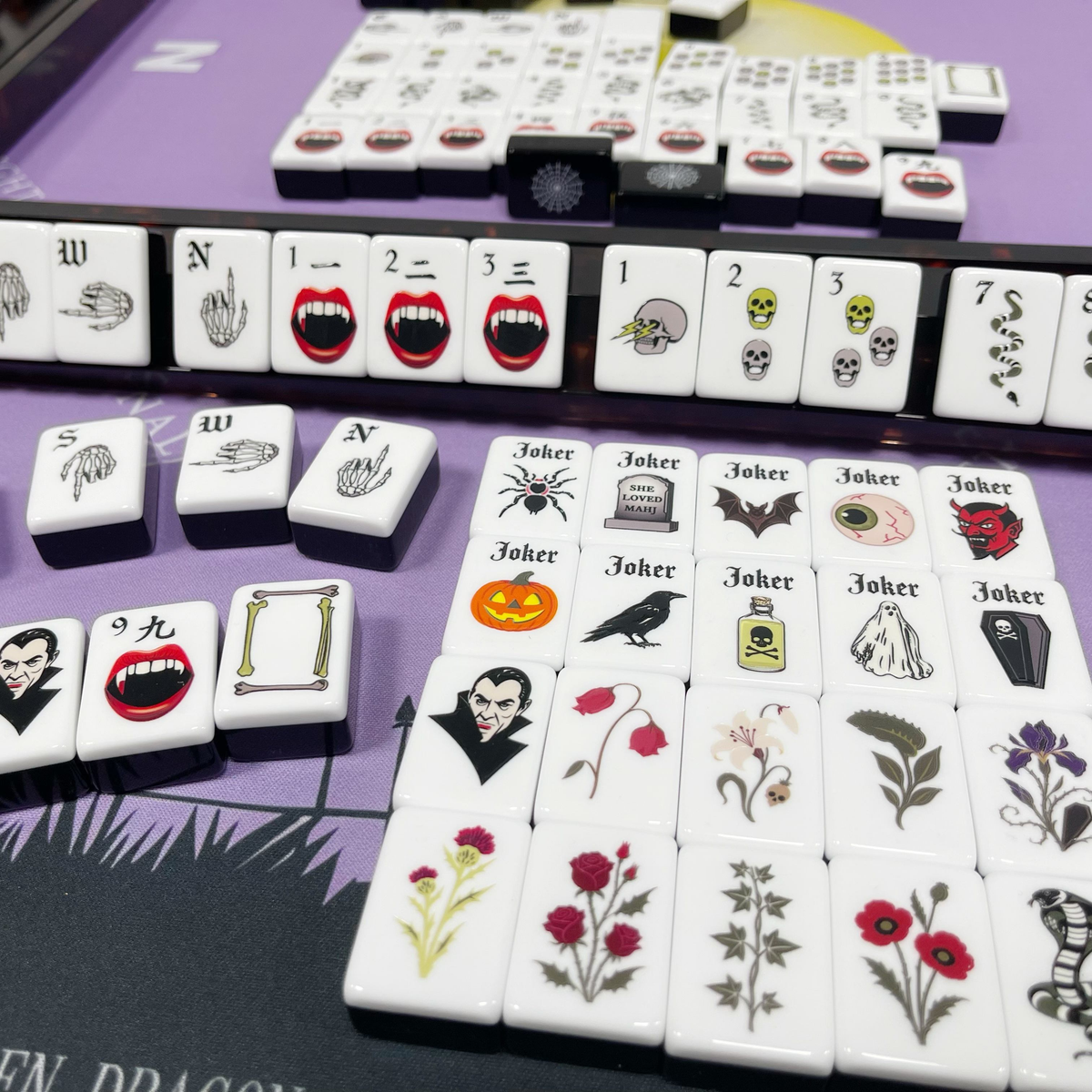 Midnight Fang Halloween acrylic American mahjong tiles in rack on purple mat — gothic joker and fang motif story, Mahjong Loft