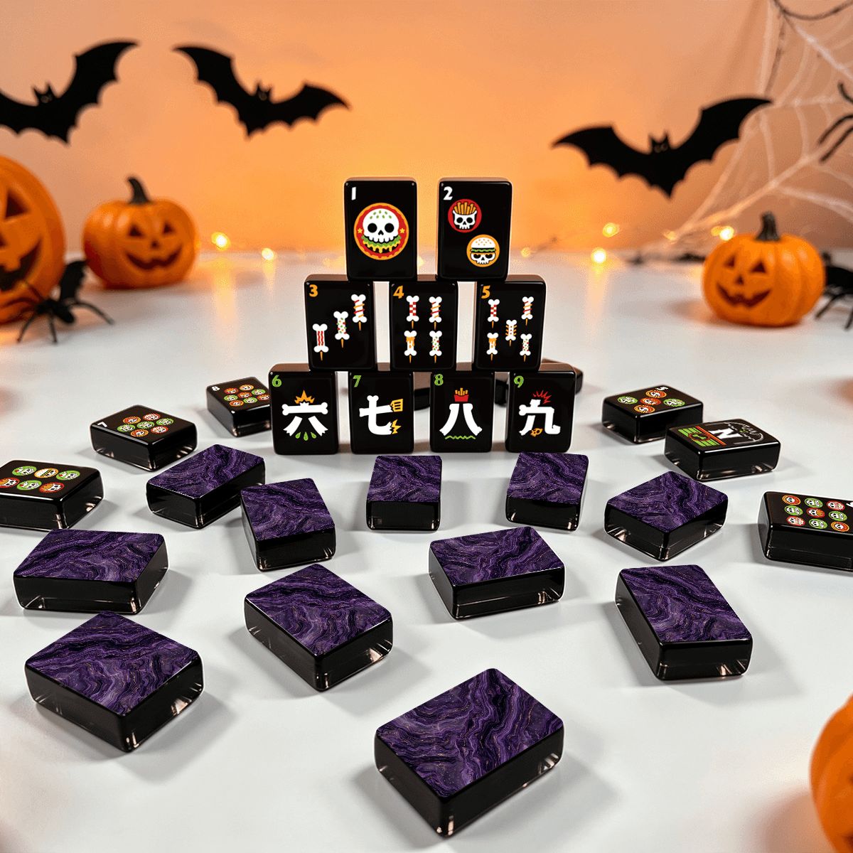 Skull Diner Halloween mahjong tile set with purple marble tile backs displayed with pumpkins, bats, and spiderweb Halloween decor